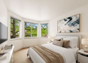 Thumbnail 4 of 20 - a bedroom with a bed and a tv and windows