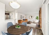 Thumbnail 2 of 19 - A modern dining room with a wooden table and blue chairs.