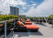 Thumbnail 2 of 20 - a roof deck with couches and tables