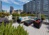 Thumbnail 3 of 20 - a seating area on a roof terrace with a view of the city
