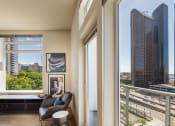 Thumbnail 8 of 20 - a living room with a large window and a view of a city