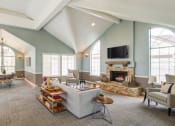 Thumbnail 19 of 20 - a large living room with a fireplace and a large window
