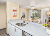 Thumbnail 9 of 26 - a kitchen with a large counter top and a sink