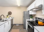 Thumbnail 7 of 26 - a kitchen with stainless steel appliances and white cabinets