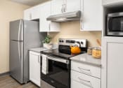 Thumbnail 6 of 26 - a kitchen with stainless steel appliances and white cabinets