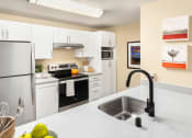 Thumbnail 5 of 26 - a kitchen with white cabinets and a sink and a refrigerator
