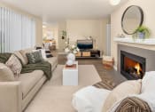 Thumbnail 3 of 26 - a living room with a fireplace and a couch