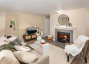 Thumbnail 2 of 26 - a living room with a fireplace and a couch