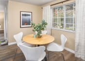 Thumbnail 10 of 26 - a dining room with a table and chairs and a window