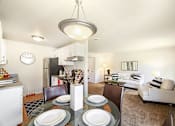 Thumbnail 17 of 30 - A modern dining room with a glass table and chairs.