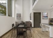 Thumbnail 13 of 22 - a dining area with a table and chairs and a kitchen in the background