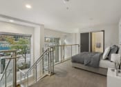 Thumbnail 14 of 22 - a bedroom with a bed and a staircase in front of it