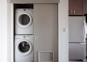 Thumbnail 5 of 38 - a washer and dryer in a kitchen next to a refrigerator