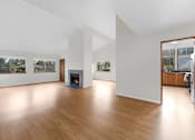 Thumbnail 14 of 41 - A room with a fireplace and a large mirror on the wall.