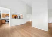 Thumbnail 15 of 41 - A kitchen with wooden floors and white walls.