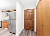 Thumbnail 13 of 41 - A kitchen with a refrigerator, dishwasher, and wooden cabinets.