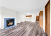 Thumbnail 18 of 41 - A room with a fireplace and wood flooring.