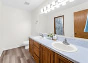 Thumbnail 28 of 41 - A bathroom with a white sink and a mirror.