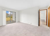 Thumbnail 20 of 41 - A room with a sliding glass door leading outside.