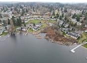 Thumbnail 41 of 41 - A small island in the middle of a lake surrounded by houses.