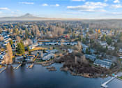 Thumbnail 30 of 41 - A small town with a lake and a mountain in the background.