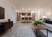 Thumbnail 14 of 34 - A modern living room with a dining area in the background.