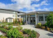 Thumbnail 1 of 34 - A modern building with a landscaped front yard.