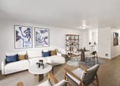 Thumbnail 1 of 29 - A living room with a white couch and a coffee table.