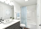 Thumbnail 4 of 29 - A bathroom with a white sink, toilet, and bathtub.