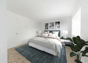 Thumbnail 11 of 29 - A bedroom with a bed, a potted plant, and pictures on the wall.
