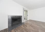 Thumbnail 20 of 29 - A room with a fireplace and wooden flooring.