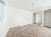 Thumbnail 24 of 29 - A room with a carpeted floor and a window.