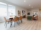 Thumbnail 14 of 18 - a living room and dining room with a table and chairs