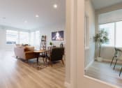 Thumbnail 18 of 18 - a living room and dining room with a table and chairs and a fireplace