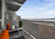Thumbnail 10 of 22 - a balcony with a view of a body of water