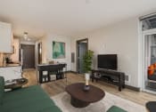 Thumbnail 8 of 22 - a living room with white walls and a green couch