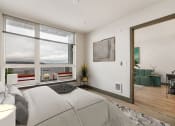 Thumbnail 9 of 22 - a bedroom with a large window and a door that leads to a living room