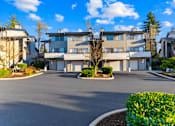 Thumbnail 29 of 37 - A large building with a driveway in front of it.