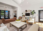 Thumbnail 21 of 38 - A living room with a couch, chairs, and a coffee table.