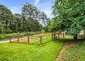 Thumbnail 34 of 38 - A wooden fence encloses a green yard.