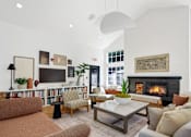 Thumbnail 19 of 38 - A living room with a fireplace and a television.