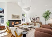 Thumbnail 6 of 38 - A living room with a fireplace and a couch.