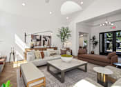 Thumbnail 20 of 38 - A living room with a white couch, a coffee table, and a fireplace.