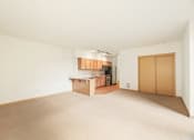 Thumbnail 31 of 42 - an empty living room and kitchen with wood floors and white walls