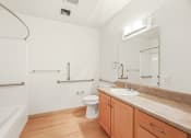 Thumbnail 36 of 42 - a bathroom with a sink and a toilet and a bath tub