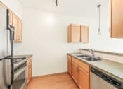 Thumbnail 18 of 42 - a kitchen with stainless steel appliances and wooden cabinets