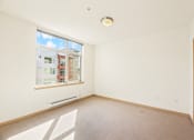 Thumbnail 20 of 42 - an empty living room with a large window and white walls