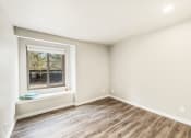 Thumbnail 14 of 40 - a living room with white walls and a window