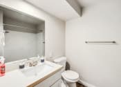 Thumbnail 25 of 40 - a bathroom with a sink and a toilet and a mirror