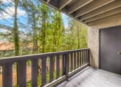 Thumbnail 40 of 40 - a balcony with a door and a view of the trees